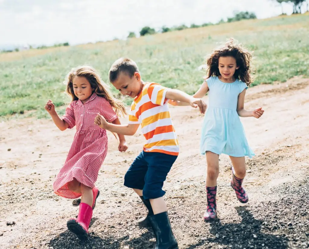 Happy farm children outdoors in the summer